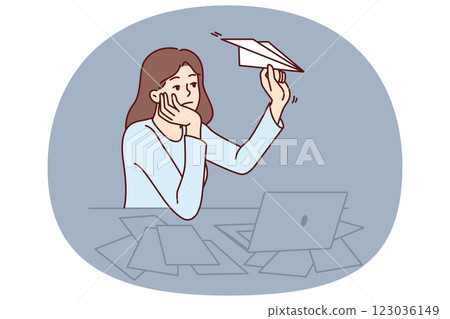 Unmotivated woman freelancer sitting at office desk with laptop and launching paper planes 123036149