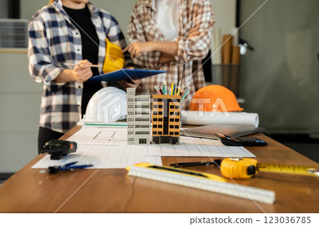 brainstorming and measuring for cost estimating on paperworks and floor plan drawings about design architectural and engineering for houses and buildings. 123036785