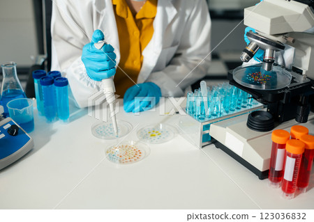 Lab work, Doctor holds a test tube takes the test from a test tube in analysis, blood, DNA, test tube stand. 123036832