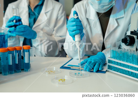 Science and medicine, scientist analyzing and dropping a sample into a glassware, experiments containing chemical liquid in laboratory on glassware, innovative and technology. 123036860