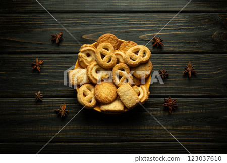 A colorful assortment of cookies sits attractively on a plate on a rustic wooden table before breakfast A colorful assortment of cookies sits attractively on a plate on a rustic wooden table before breakfast 123037610