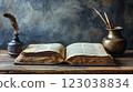 Vintage Open Book on Wooden Table with Quill and Inkwell 123038834