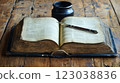 Vintage Open Book on Wooden Table with Quill and Inkwell 123038836