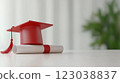 Graduation cap and diploma on white table with blurred green background 123038837