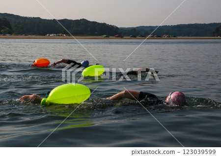 Swimmers Practice With Buoyancy Aids During a Summer Day at the Lake 123039599
