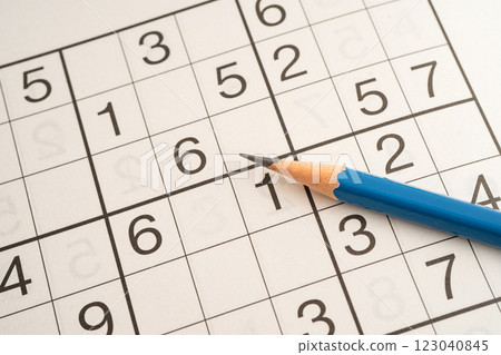 Sudoku puzzle game playing to challenge brain. Sudoku puzzle game playing to challenge brain. 123040845