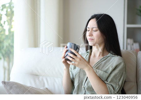 Asian woman complaining about coffee bad taste Asian woman complaining about coffee bad taste 123040956