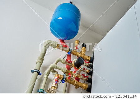 Closed heating system featuring expansion tank, pipes, and shut-off valves, ensuring efficient thermal expansion control 123041134