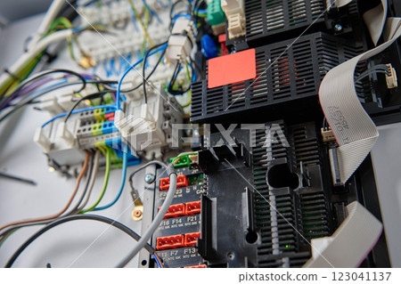 Close-up view of wiring system and circuit board inside electrical control panel. Electrical components used for automation and regulation of various systems 123041137