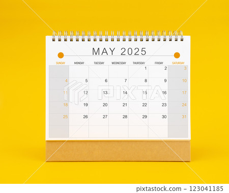 May 2025 desk calendar on yellow color background. 123041185