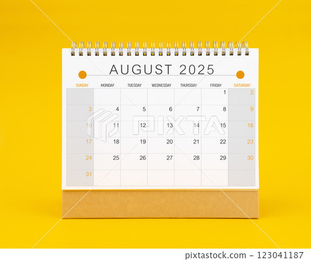 August 2025 desk calendar on yellow color background. 123041187