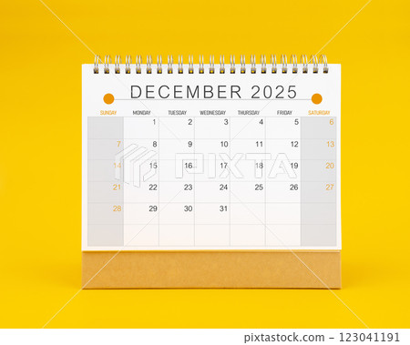 December 2025 desk calendar on yellow color background. 123041191