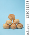 Pyramid stack of Cheese buns on the blue background 123041223