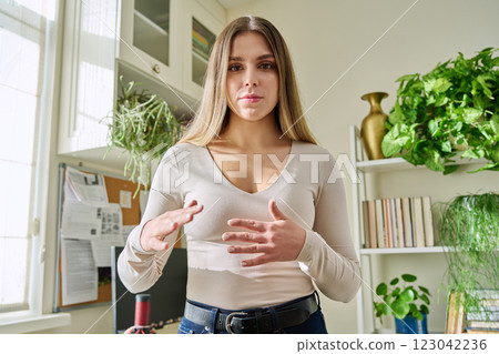 Web cam view of young attractive woman talking in home interior Web cam view of young attractive woman talking in home interior 123042236