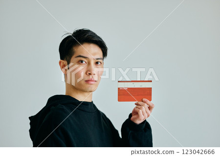 A young man in his twenties holding a bankbook 123042666