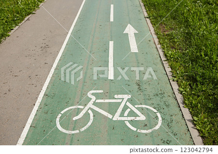 Bike path in the park against the background of grass. Bike path in the park against the background of grass. 123042794