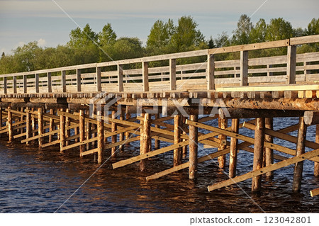 Wooden bridge with fences, log structure on stilts Wooden bridge with fences, log structure on stilts 123042801