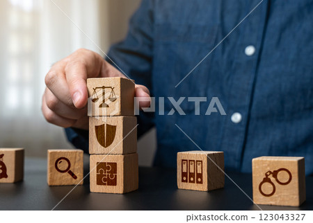 A man collects the components of the judicial system and legislation. Law, legal structure, justice, courts, legal framework, and policymaking. 123043327