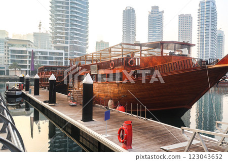 City pier with a large wooden pleasure boat standing 123043652