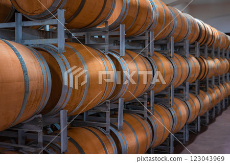 Stacked wooden barrels in winery for wine fermentation and aging Stacked wooden barrels in winery for wine fermentation and aging 123043969