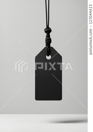 Blank empty mockup of tag label on rope. paper black tag label or sticker 123044413