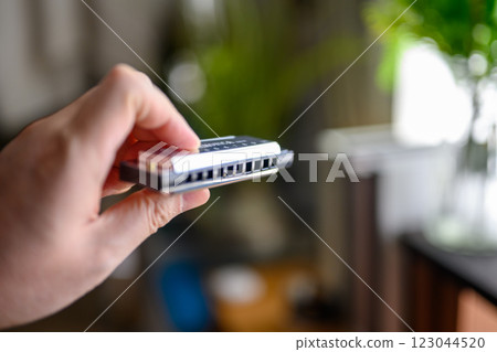 Man with harmonica 123044520