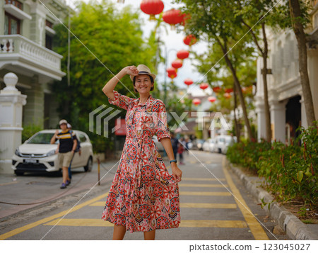 woman exploring streets of George Town, during Chinese New Year. 123045027