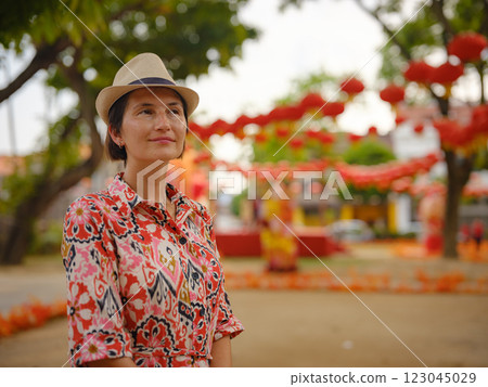 woman exploring streets of George Town, during Chinese New Year. 123045029