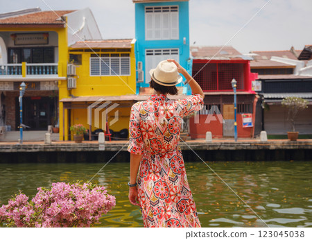 woman in dress and hat exploring vibrant streets of Malacca, Malaysia. woman in dress and hat exploring vibrant streets of Malacca, Malaysia. 123045038
