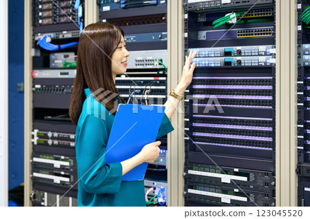 Female engineer working in a server room. Photo courtesy of Sky Perfect Tokyo Media Center. 123045520