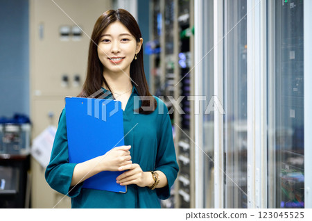 Female engineer working in a server room. Photo courtesy of Sky Perfect Tokyo Media Center. 123045525