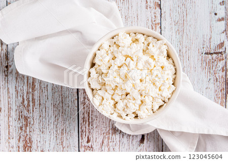 Close up of a bowl of fresh cottage cheese for breakfast on the table top view 123045604