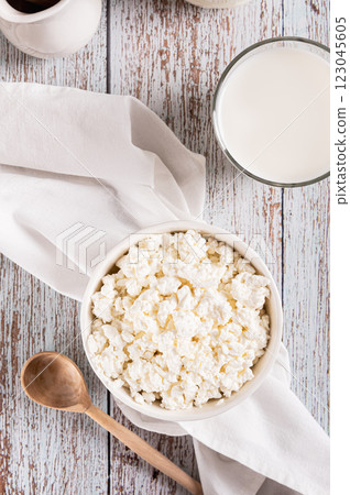 Farm homemade cottage cheese in a bowl on the table top and vertical view 123045605