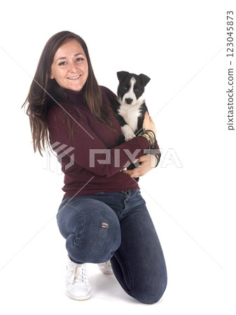 puppy border collie and woman in studio 123045873