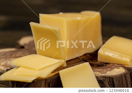 a piece of sliced hard mature cheese in close-up 123046018