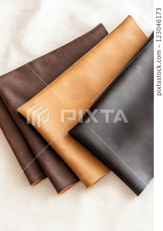 Assorted leather fabric swatches displaying different colors and textures. 123046173