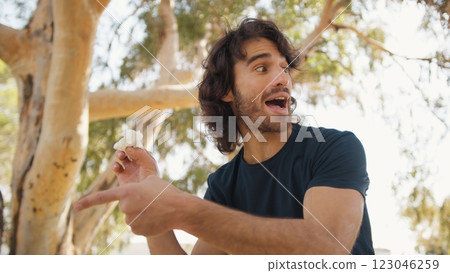 Young Man Gets Angry About Papers Thrown On The Ground, Environmental Pollution Young Man Gets Angry About Papers Thrown On The Ground, Environmental Pollution 123046259