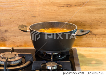 The process of cooking a hot dish in the kitchen The process of cooking a hot dish in the kitchen 123046736