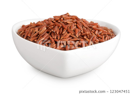 red rice in a ceramic bowl isolated on white background 123047451