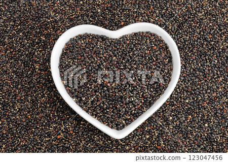 black quinoa in ceramic bowl as a background. Top view. Flat lay black quinoa in ceramic bowl as a background. Top view. Flat lay 123047456