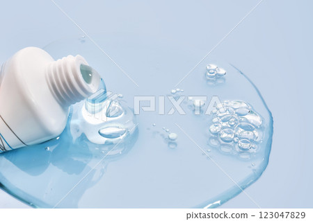 Shampoo pouring out of a small tube on a blue background. Texture. Shampoo pouring out of a small tube on a blue background. Texture. 123047829