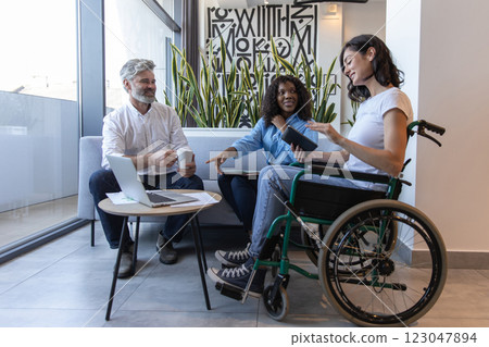 Diverse group of professionals including woman in wheelchair, brainstorming ideas for business 123047894