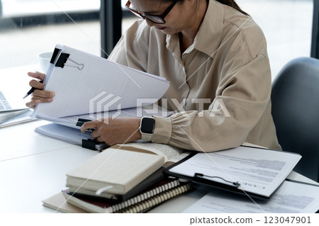 Elder businesswoman in casual attire is thinking while sitting Elder businesswoman in casual attire is thinking while sitting 123047901