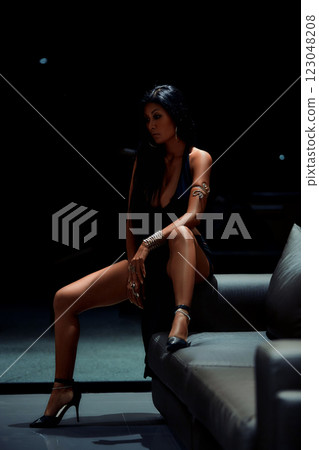 Sexy asian girl in black dress posing on sofa 123048208