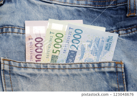 West African Franc in the pocket of blue jeans West African Franc in the pocket of blue jeans 123048676