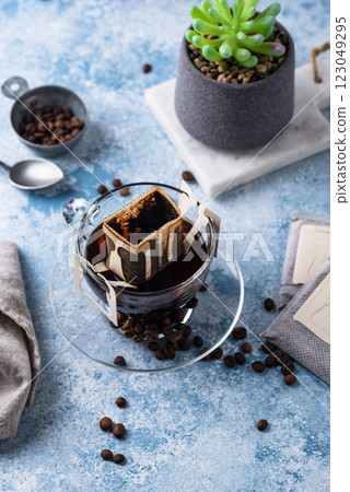 Freshly brewed drip coffee in glass cup Freshly brewed drip coffee in glass cup 123049295