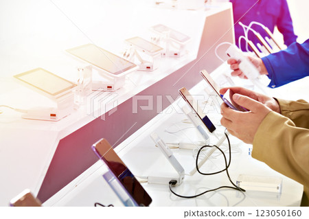 Buyer hands with mobile smartphones in electronics store 123050160