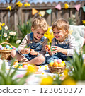 Children Enjoying an Easter Egg Hunt in a Sunny Garden Filled With Flowers and Festive Decorations 123050377