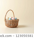 Decorative Pastel Eggs in a Woven Basket Set Against a Neutral Background Perfect for Spring Celebrations 123050381