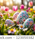 Decorative Easter Eggs Nestled Among Colorful Spring Flowers in a Sunny Garden at Dawn 123050382